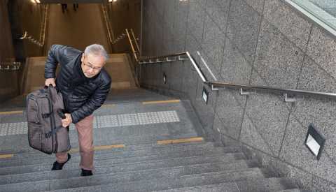 man walking up the stairs with suitcase man walking up the stairs with suitcase