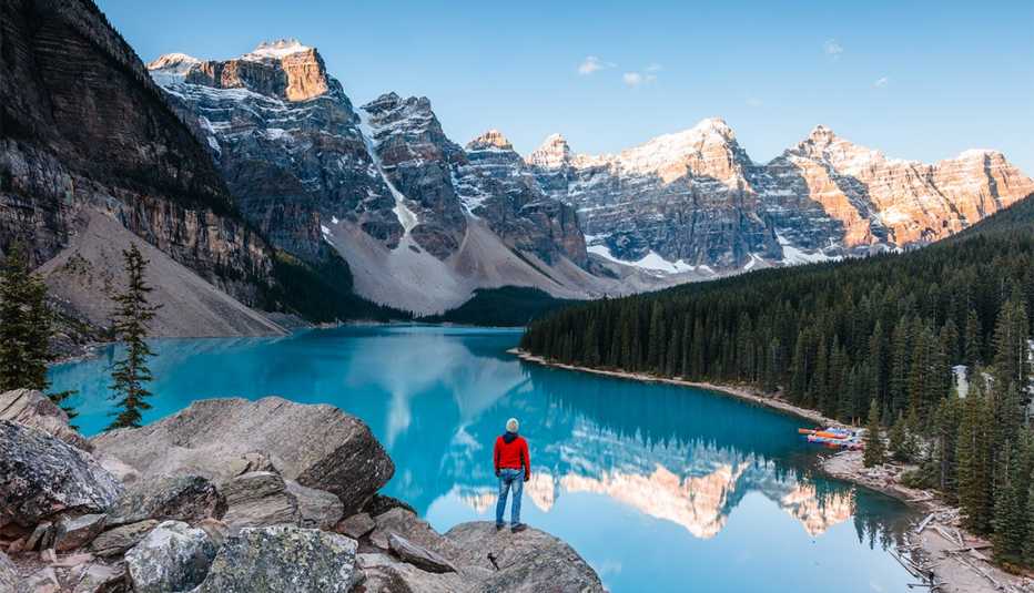 Man looking at Moraine lake at sunrise, Banff National Park