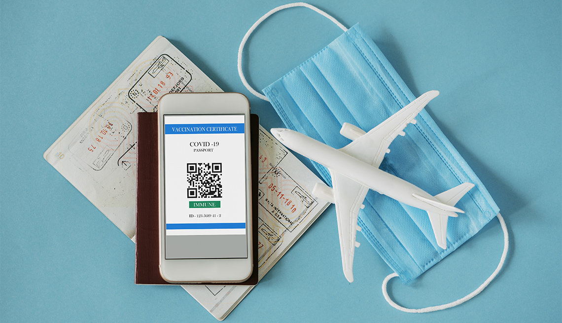 QR code for verification of immunization after COVID-19 vaccination, passport, facial protective mask on blue background