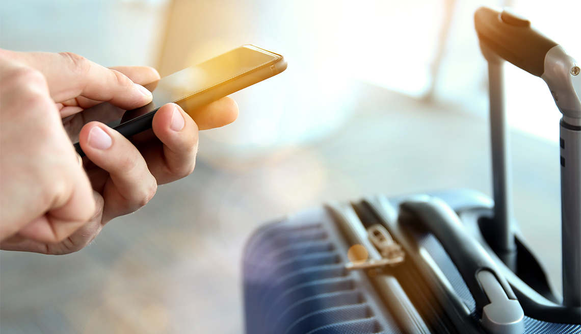 Passengers waiting at the airport using phone