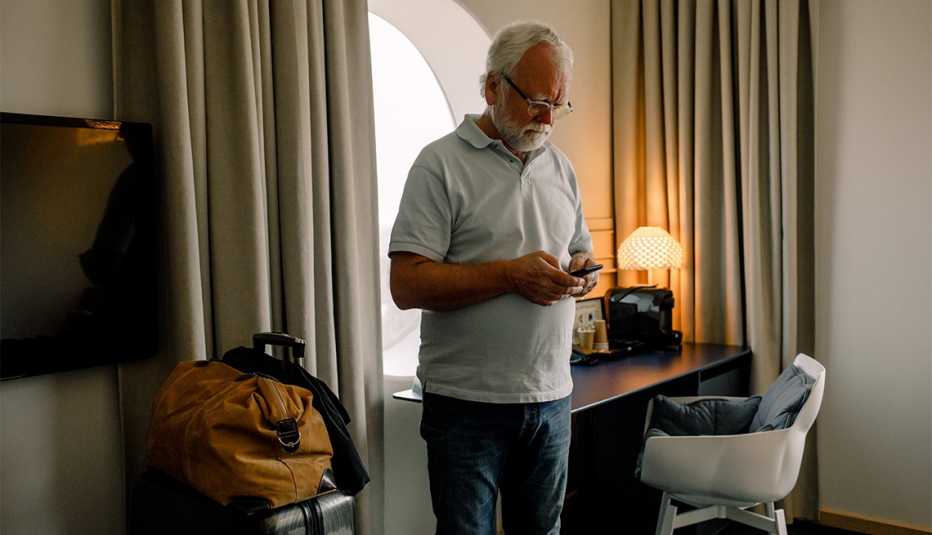 man quarantined in a hotel room with his luggage nearby