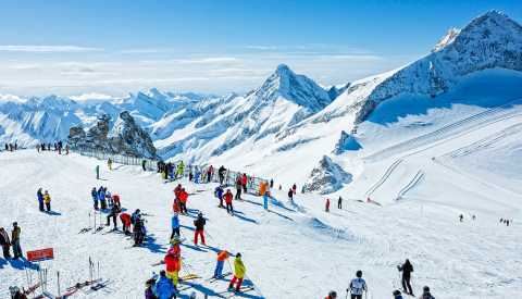 skiiers on mountain full of snow skiiers on mountain full of snow