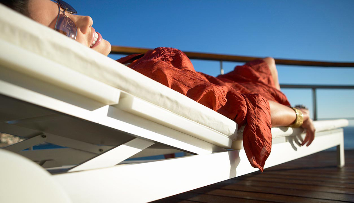 Woman Lounging On Deck Chair On Cruise Ship, How To Prevent Motion Sickness