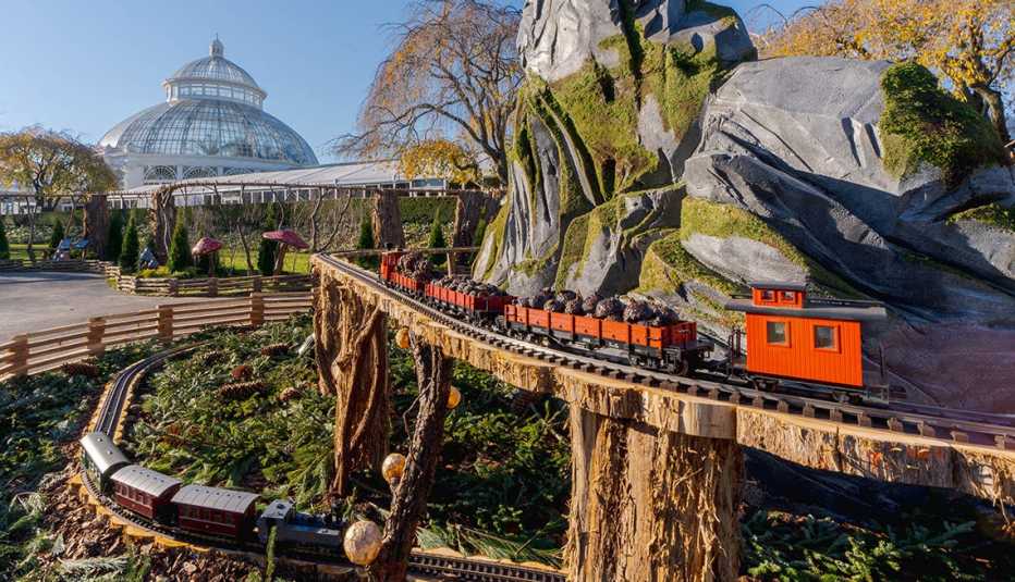 model trains pass above and below each other at the new york botanical garden
