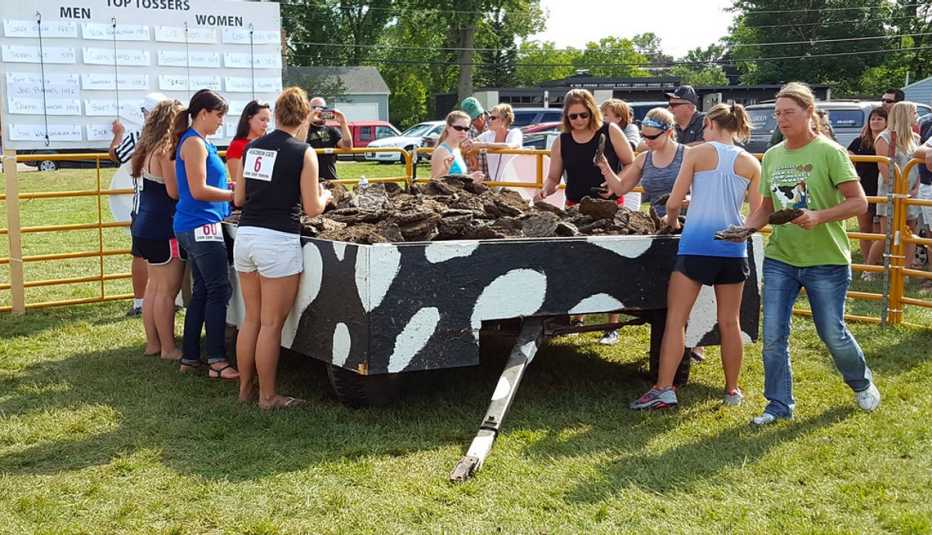 contestants at the cow chip festival prepare to throw dried discs of cow dung