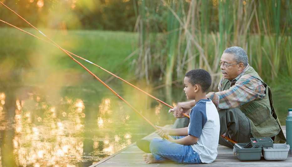 grandfather and grandson fishing on a pier