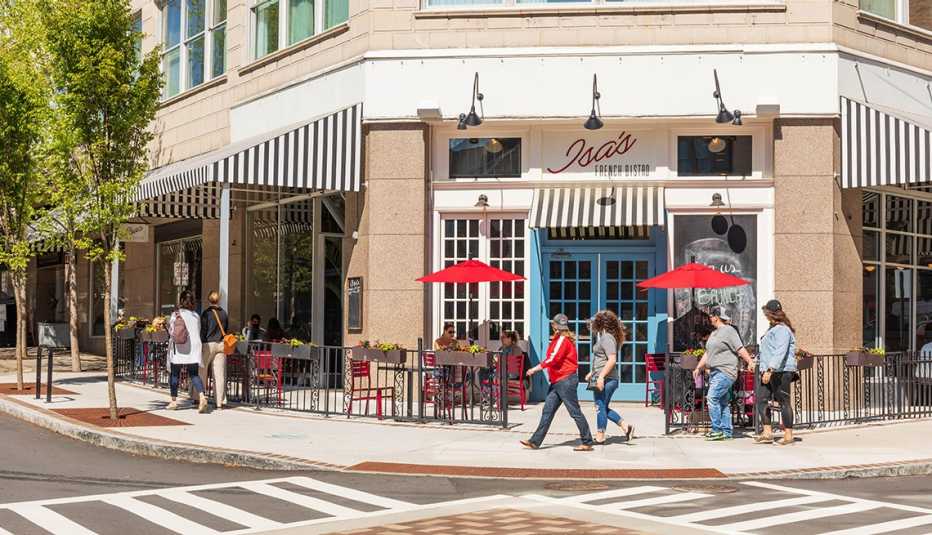Isa's French Bistro, on a downtown corner in Asheville, North Carolina, with people seated at outside tables, and other walking by.