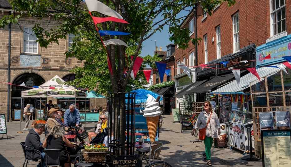 outside of cafes and shops in the centre of warwick; people walking, sitting at tables