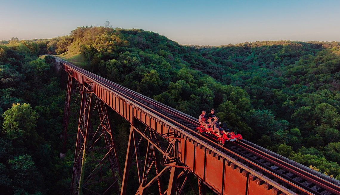people in boone iowa riding a rail car on an open railroad track