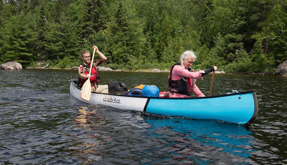 Two people paddle a canoe in Quebec Two people paddle a canoe in Quebec