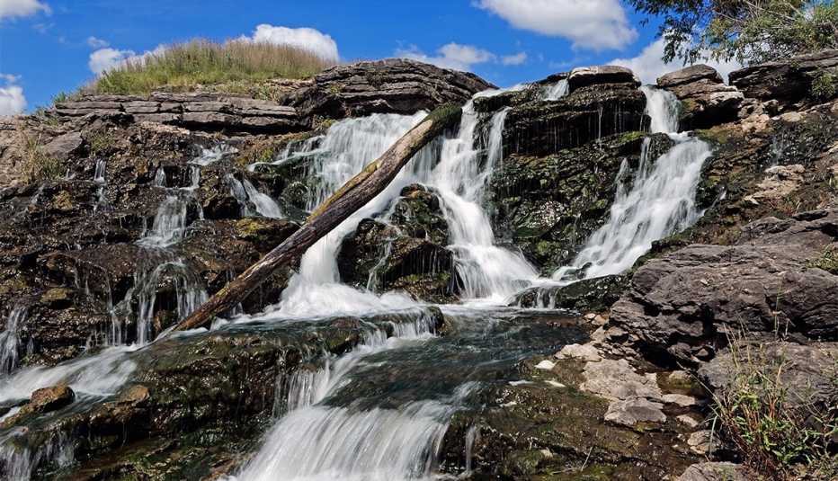 water rushes over the Lake MacBride Waterfall.