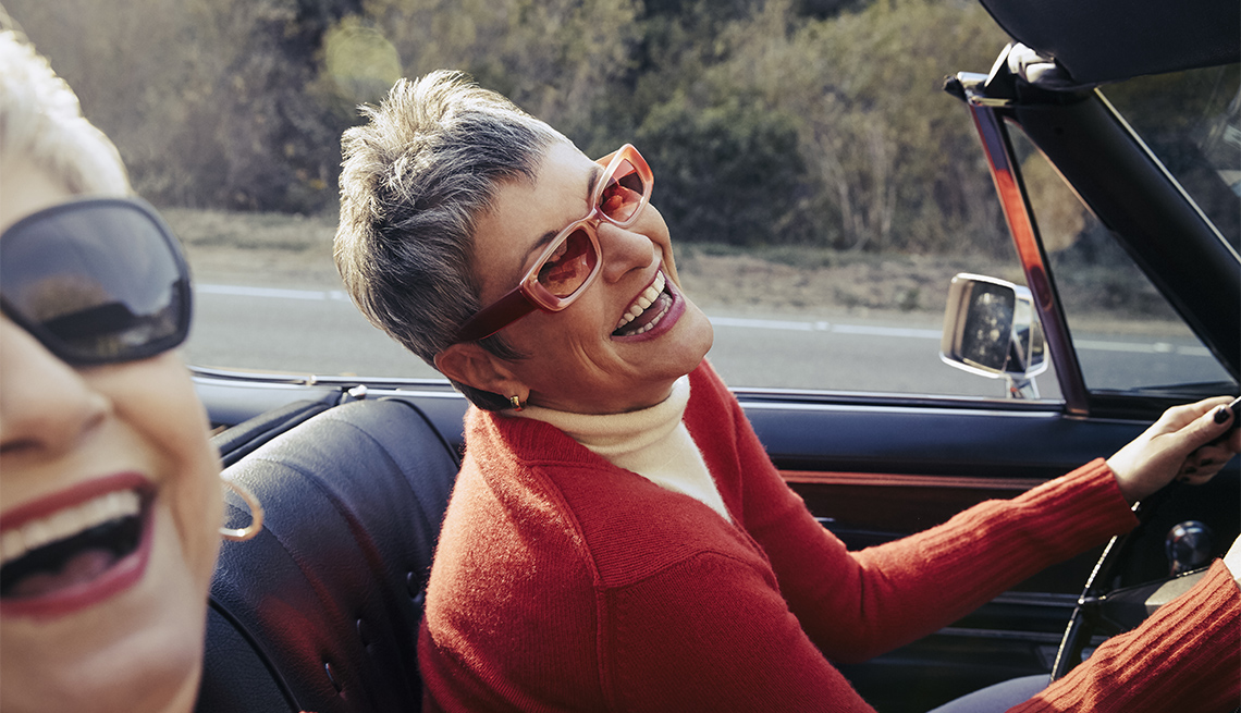 two women smiling while on a road trip