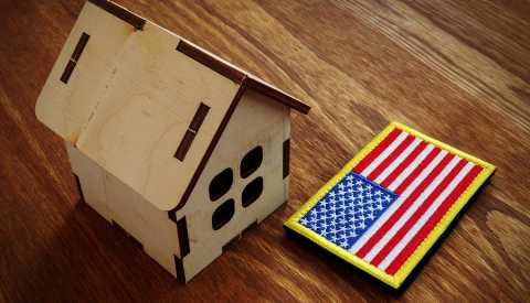 american flag and small house