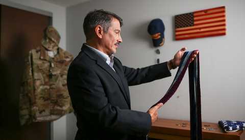 veteran christian cashmir looks at different ties to choose one to wear veteran christian cashmir looks at different ties to choose one to wear