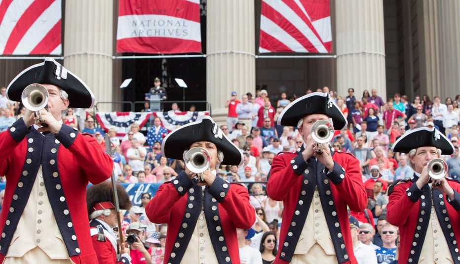 group of four buglers dressed in period costumes