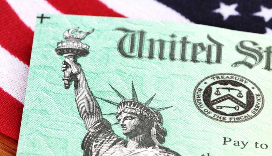 A check from the U S Treasury on an American Flag