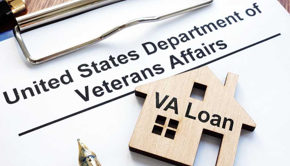 Loan paperwork with a key in the shape of a house