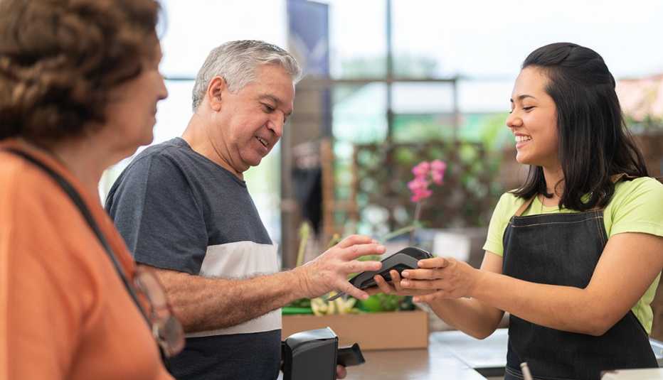 A man is buying something from a shop