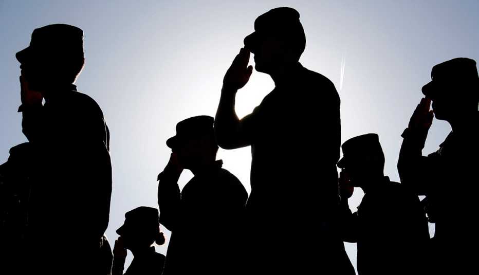 Several soldiers salute the flag Several soldiers salute the flag