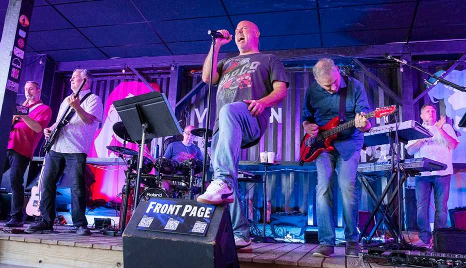 front page performs together on stage