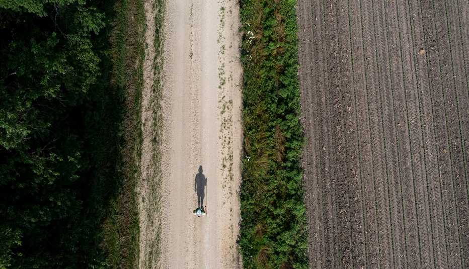 Kenneth Mintz walks along a road