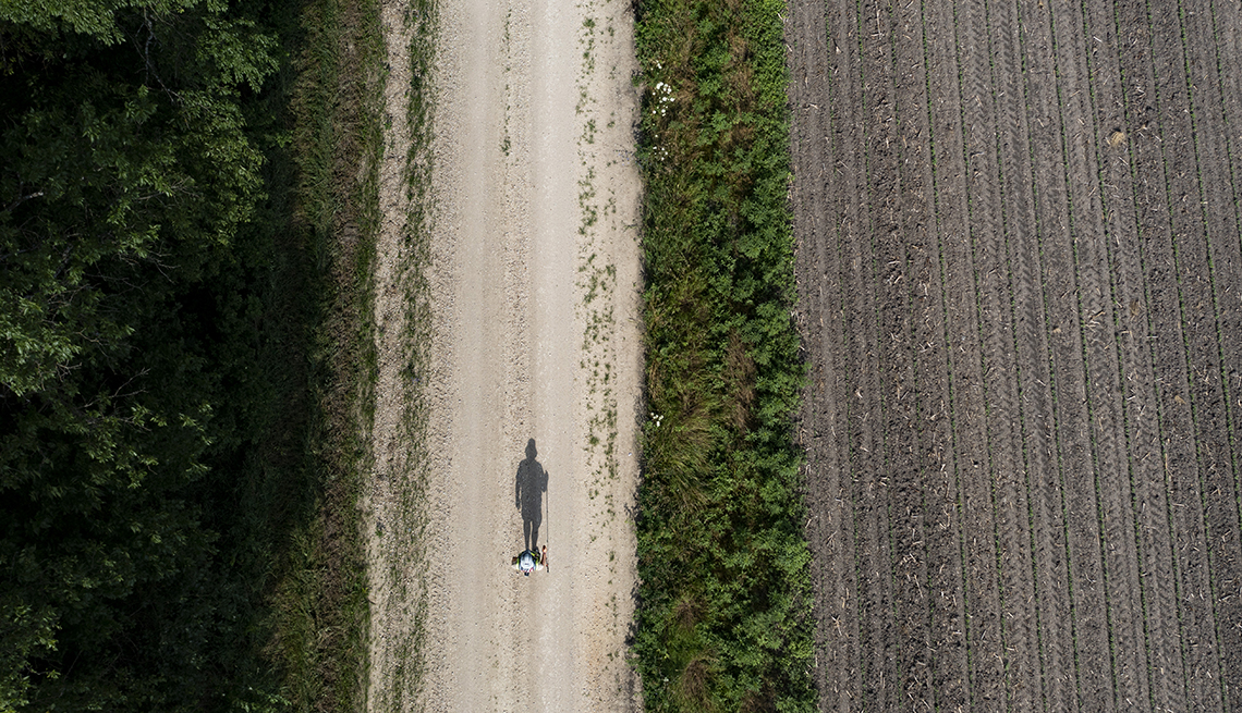 Kenneth Mintz walks along a road
