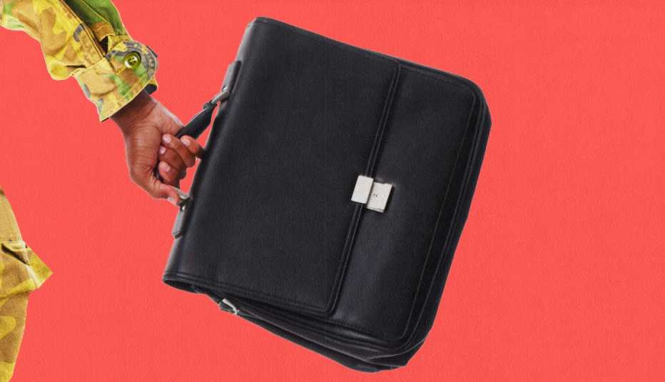 a black case being held with a red background
