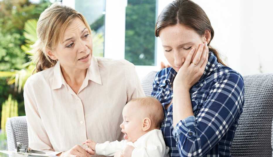 An older woman is talking with a young mother and her child An older woman is talking with a young mother and her child
