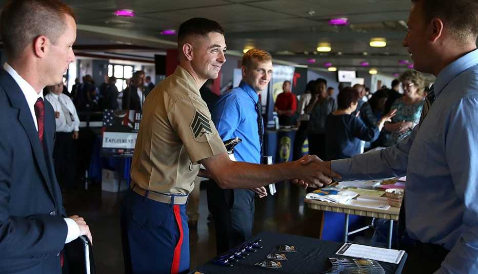 a veteran is shaking the hand of another man