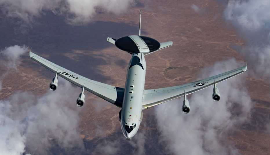 An air force plane flies through the sky