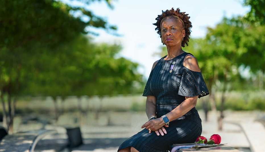 Retired Army Col. Marilyn Wills sits on a bench at the Pentagon 9/11 Memorial that honors her former officemate, Marian Serva, who was a congressional affairs contact officer for the Army that died in the 9/11 attack on the Pentagon, in Arlington, Va., on Tuesday, August 23, 2022. Col. Wills was working at the Pentagon on Sept. 11, 2001, when a highjacked airplane crashed into the building. She helped lead people to safety, including a woman she carried on her back