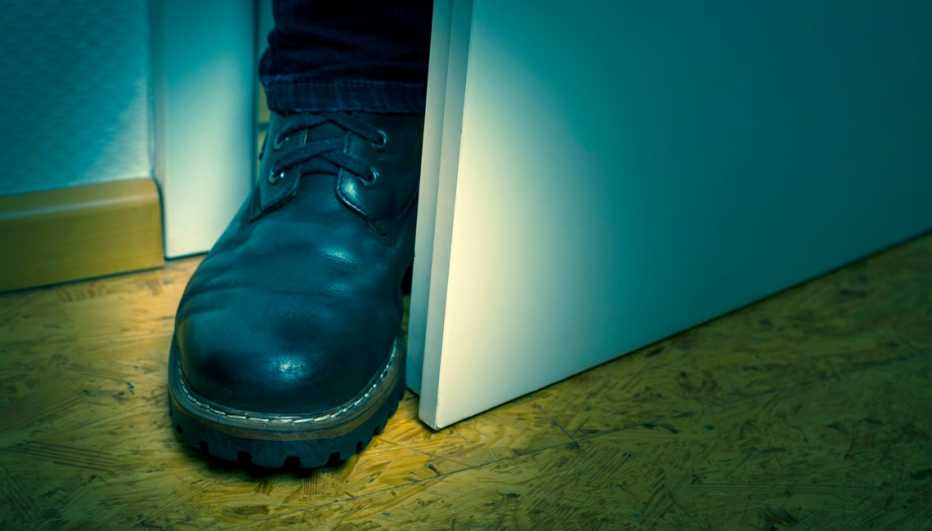 a black boot is blocking a door