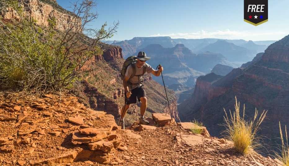 a man is hiking along a cliff
