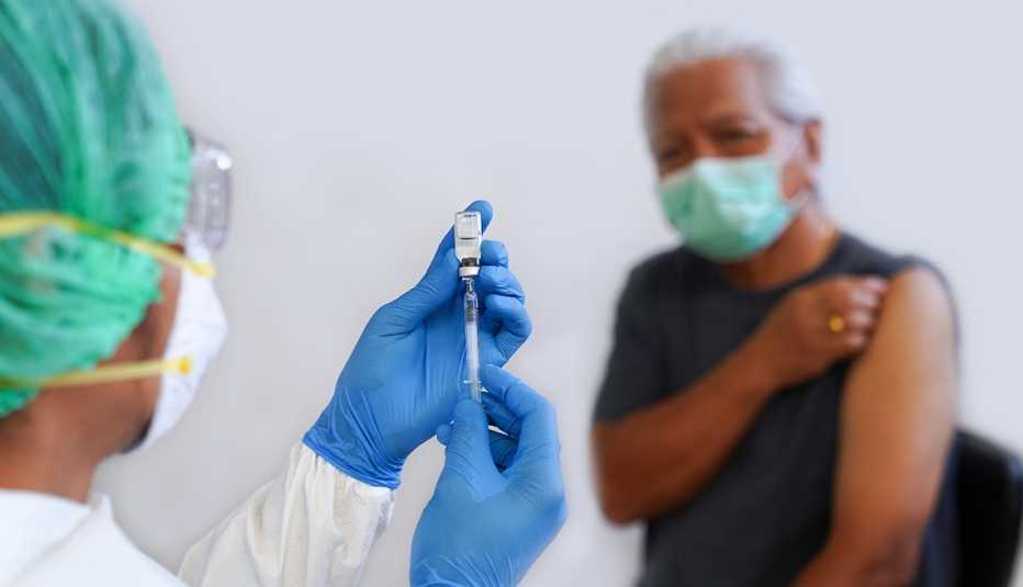 A doctor is about to give a shot to a patient