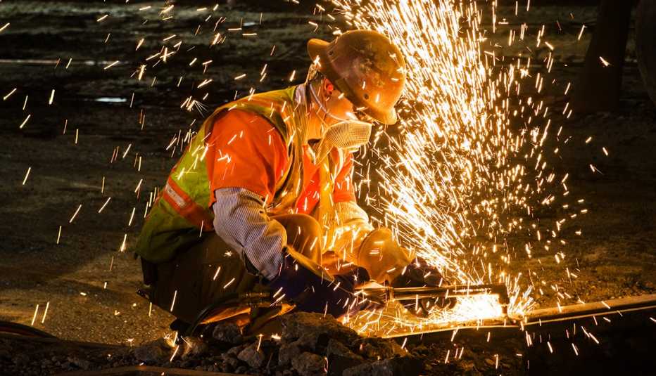 a welder in safety gear working on a rail
