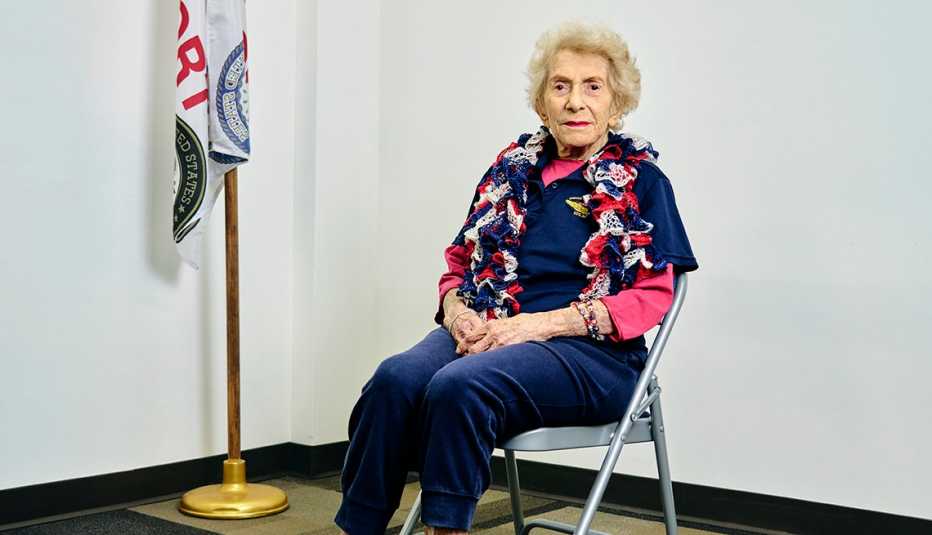 world war ii veteran ethel margolin poses for a photo next to a flag