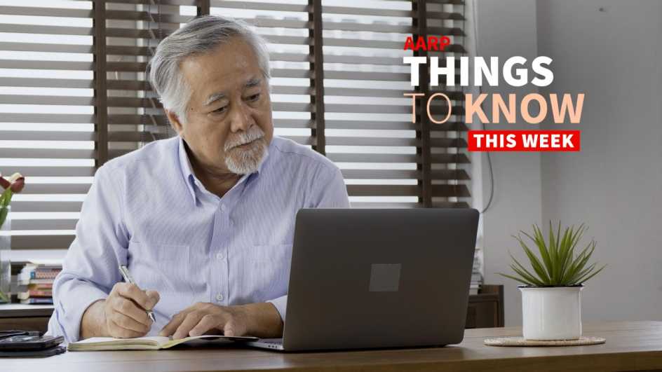 a photo shows an older adult man looking at a laptop while writing on a notepad