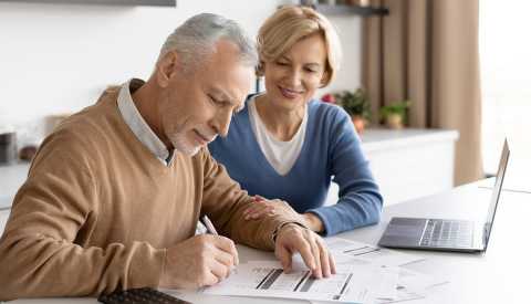 a man and woman looking at papers