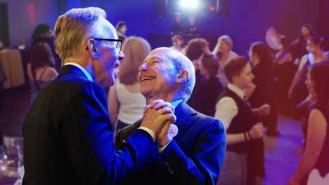 a photo shows two men slow dancing   