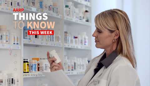 a person looking at pill bottles