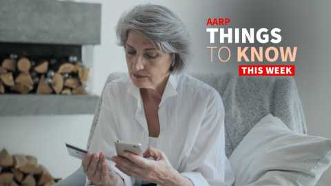 a photo shows an older adult woman looking at her smartphone while reading her credit card number
