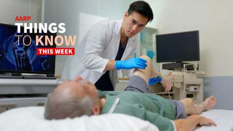 a photo shows a medical worker caring for an older adult man at a medical facility