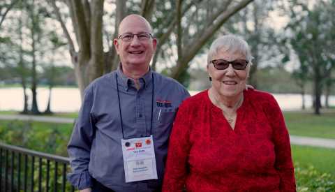 two people standing while posing for a picture
