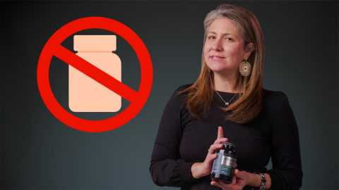 women holding a supplement bottle