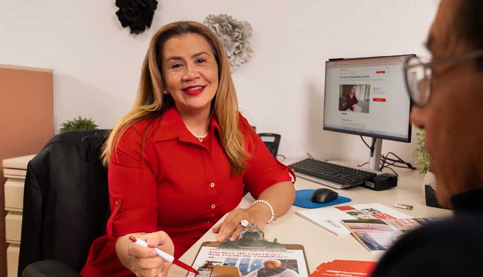 a woman sitting at a table in an office