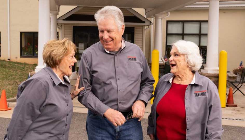 Smiling Tax-Aide volunteers sharing a joyful moment together
