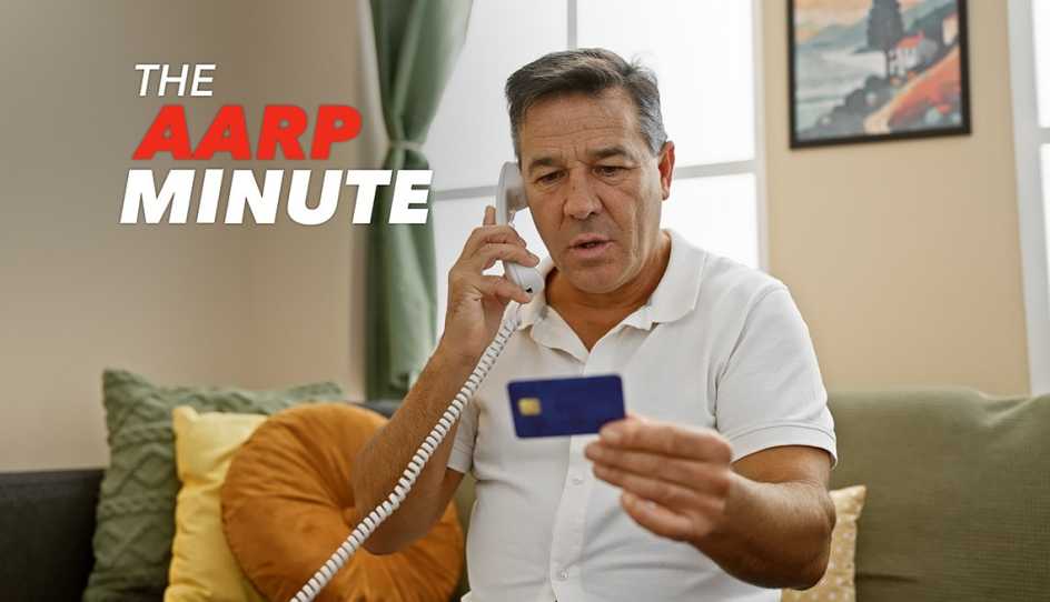 a man talking on a phone while holding a credit card in his hand