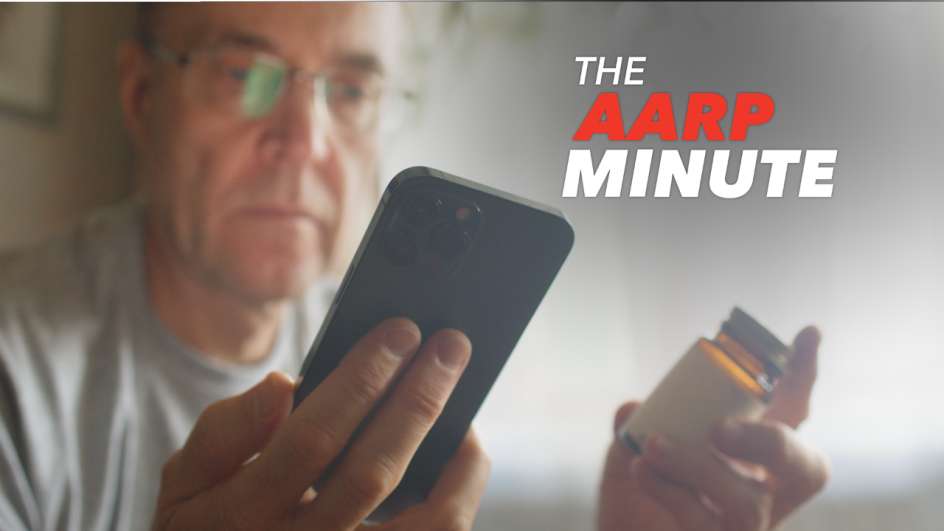 man holding a mobile phone and a pill bottle
