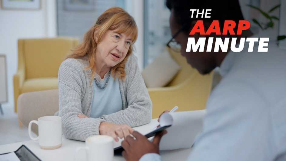 a woman sitting at a table talking to a man sitting across from her holding a tablet