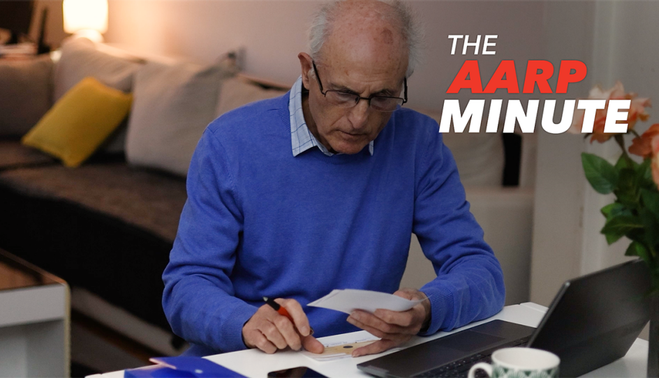 a man working on something at his desk with paper in his hands